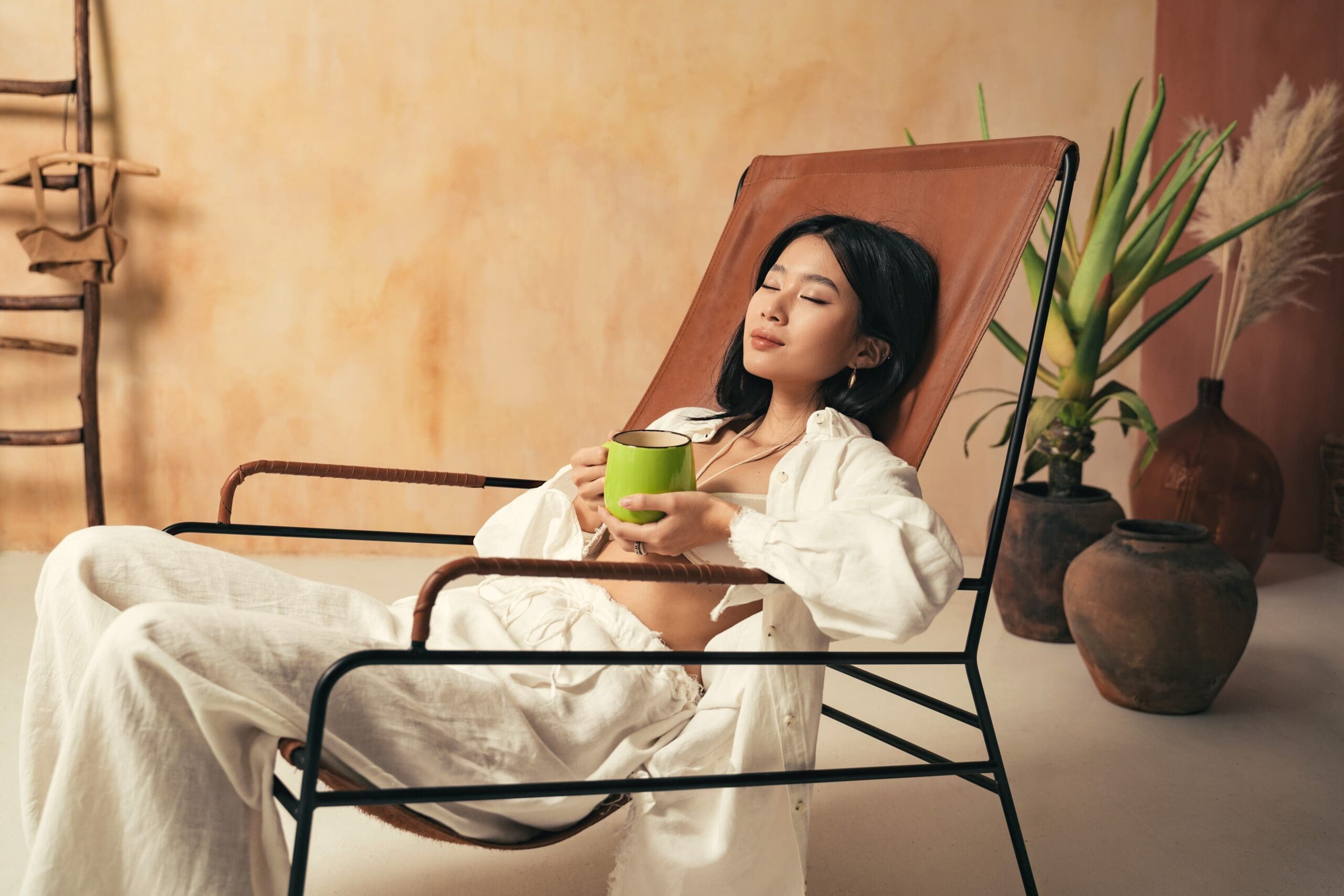 asian-girl-relaxing-on-lounger-with-mug-of-tea-me-2023-11-27-05-03-17-utc pic